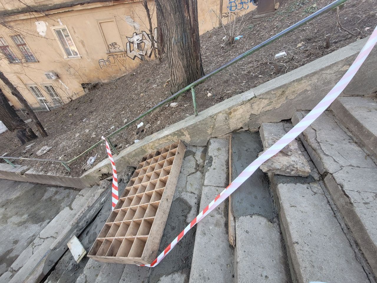 Участок лестницы зацементировали и оградили деревянной перегородкой.